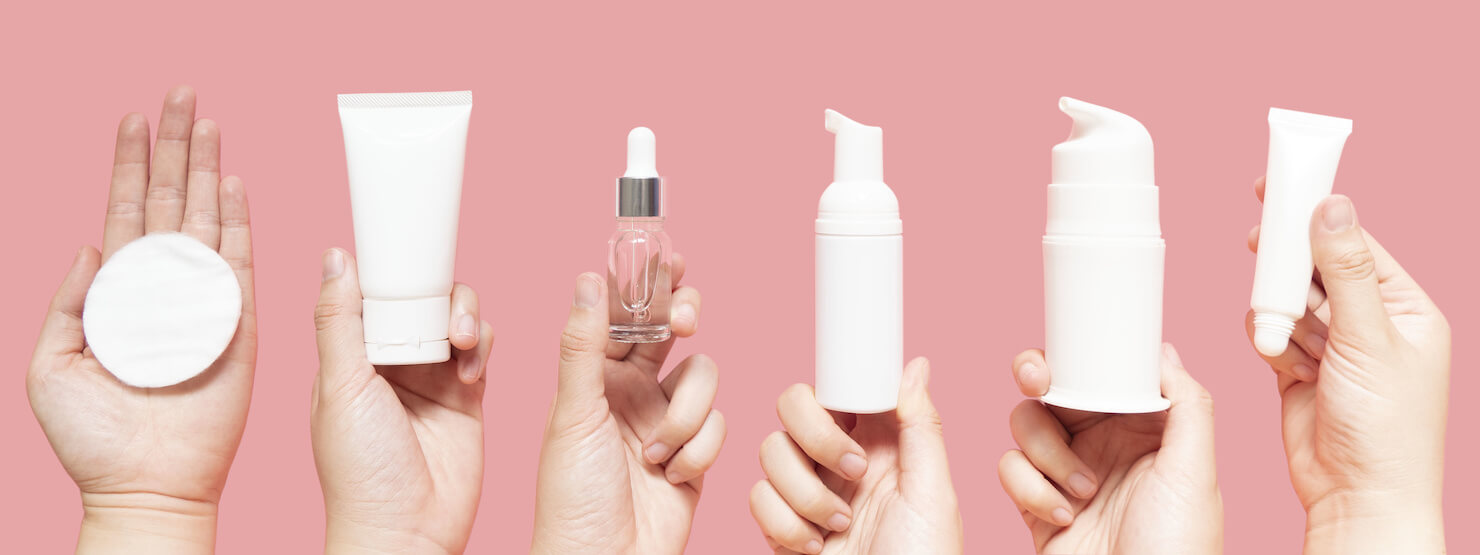 Hands holding generic skin care products for skin health