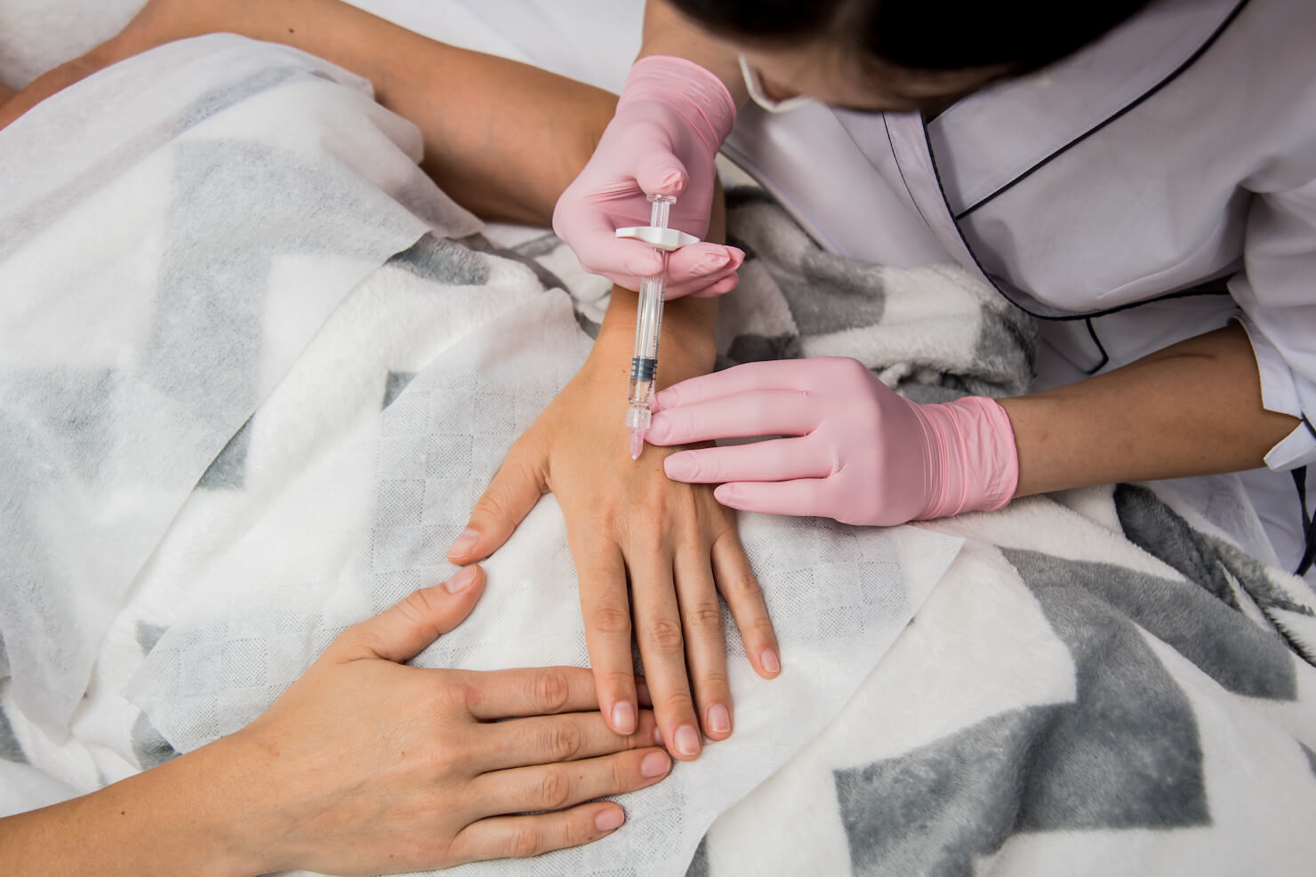 Dermal filler being injected into hands to hide veiny hands