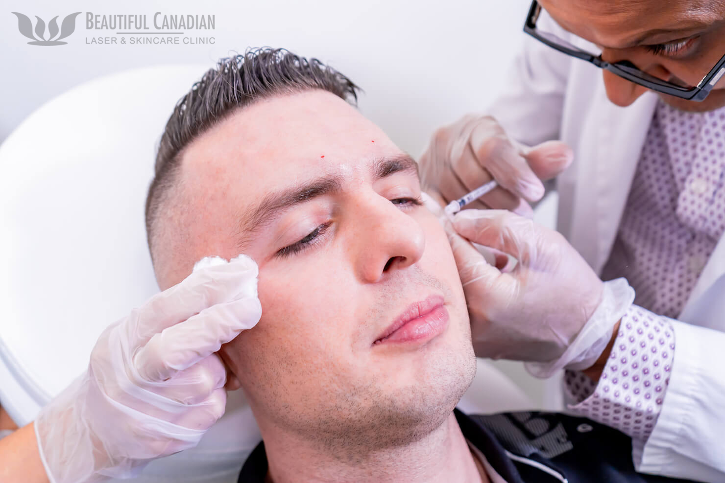 Doctor and assistant hands performing a Surrey Botox treatment for eye wrinkles on a male patient