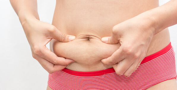 woman pinching belly fat