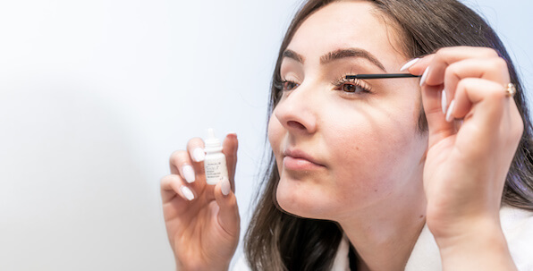 woman applying latisse eyelash growth serum to eyes